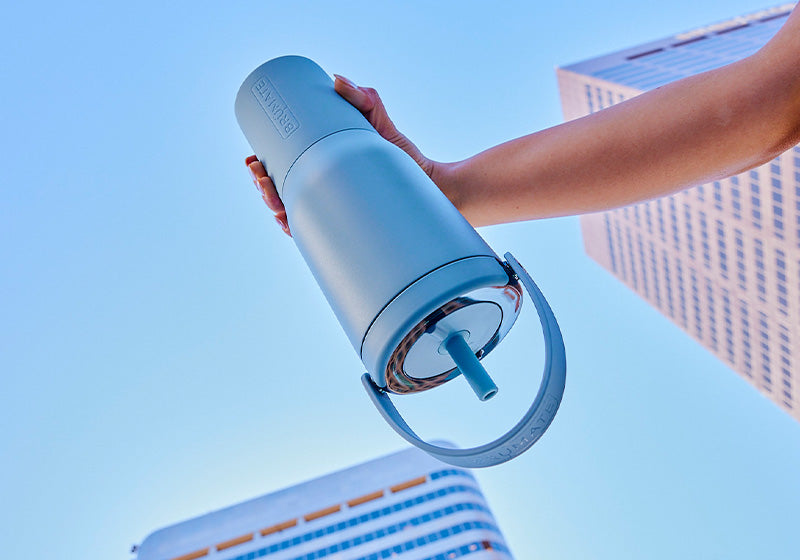 Person holding a Resa Tumbler upside down, inside of cooler