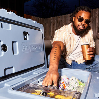Man reaching into BruTank 55qt grabbing a soda can