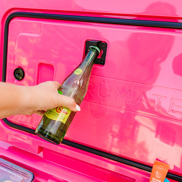 Woman using the built-in bottle opener inside the BruTank