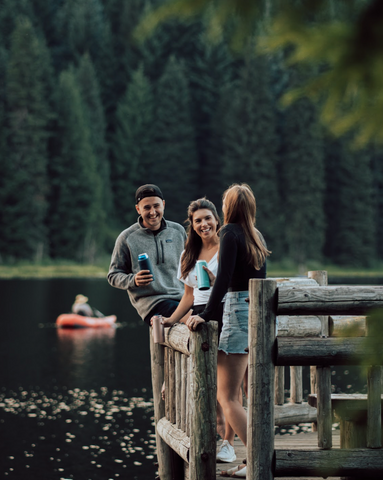 people standing on a dock talking.